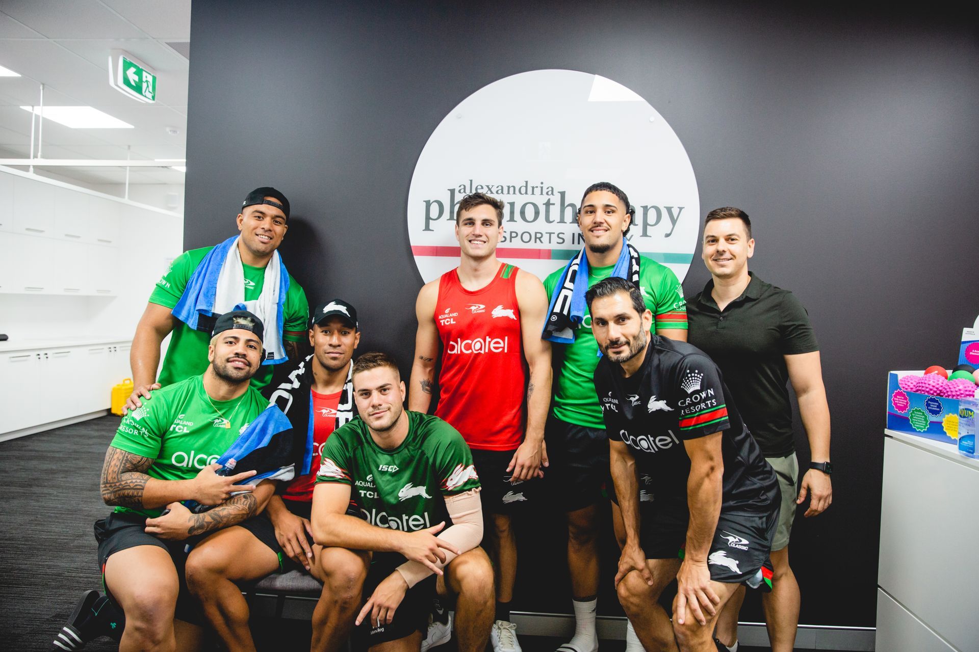 A group of men are posing for a picture in a gym.