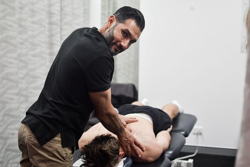 A man is giving a man a massage on a table.