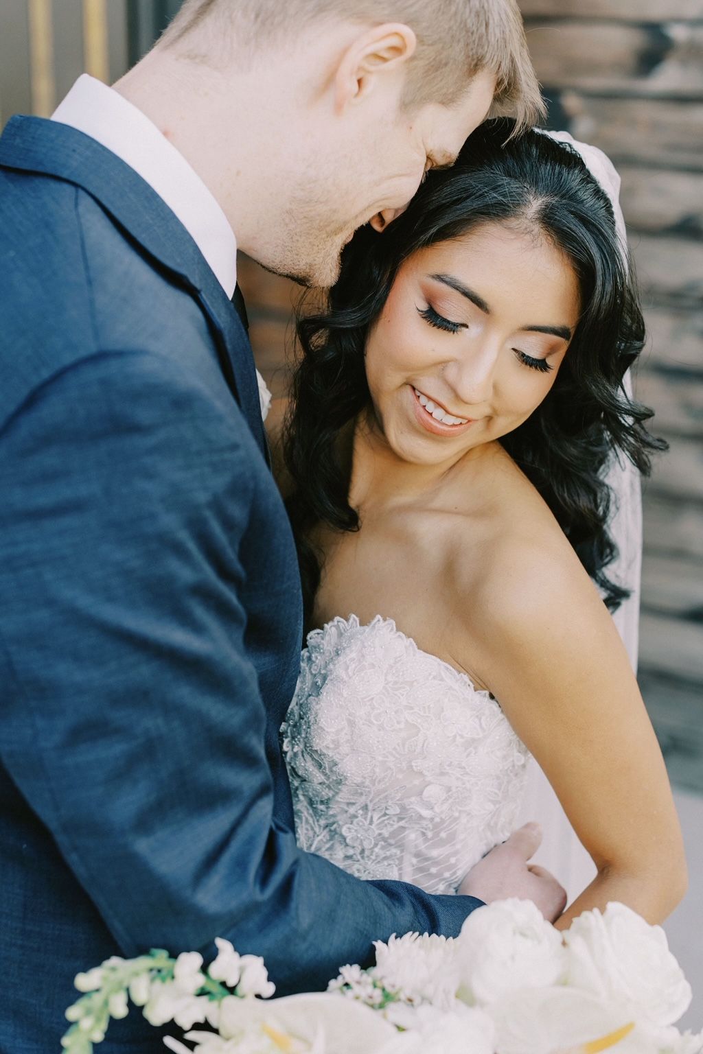A bride and groom are posing for a picture on their wedding day.