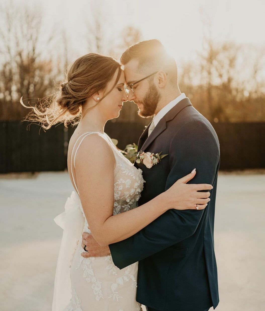 A bride and groom are hugging and looking into each other 's eyes
