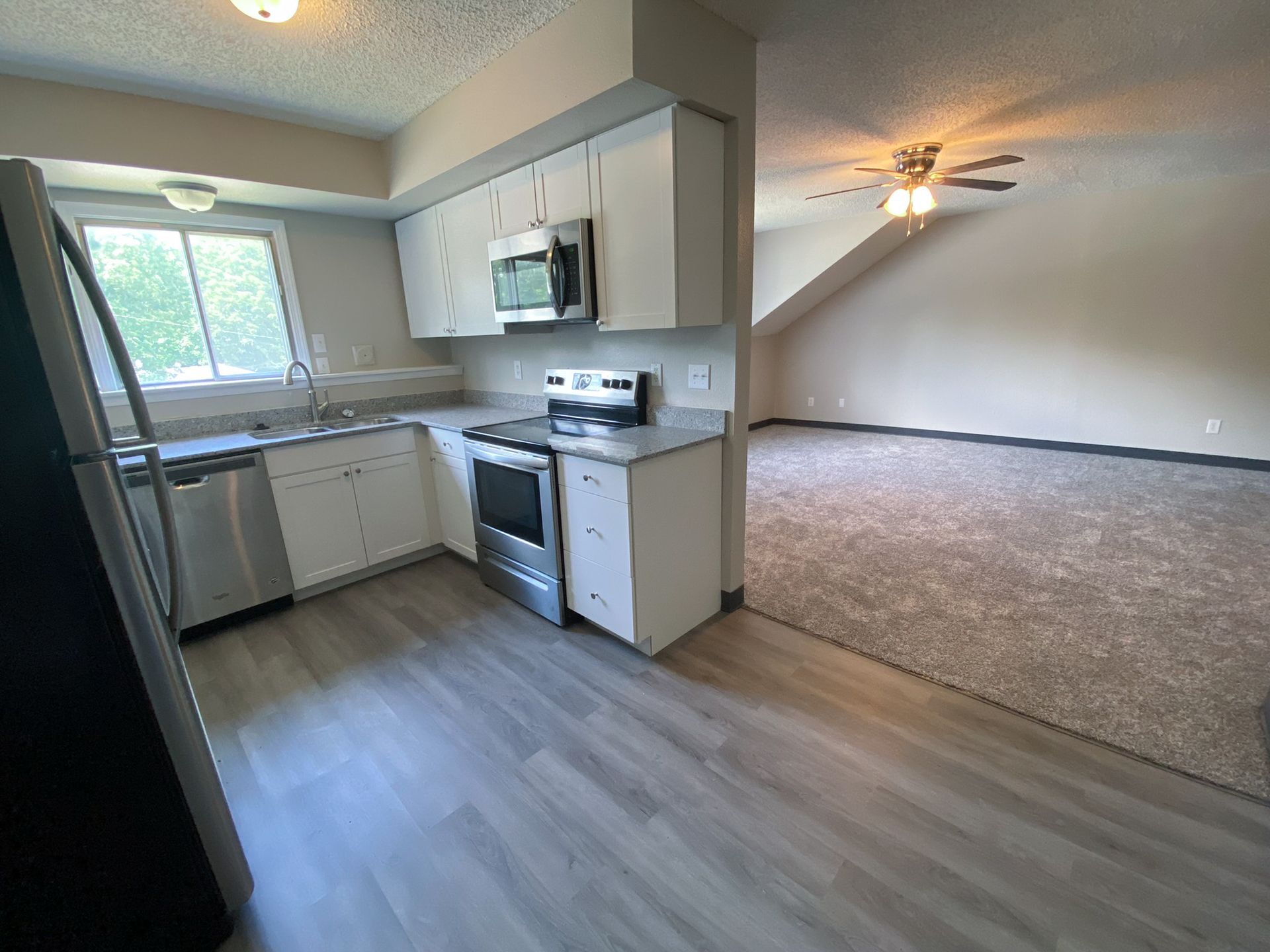 Interior view of a modern apartment unit at Unique Apartment Homes in Ames, IA, featuring spacious living areas and contemporary finishes