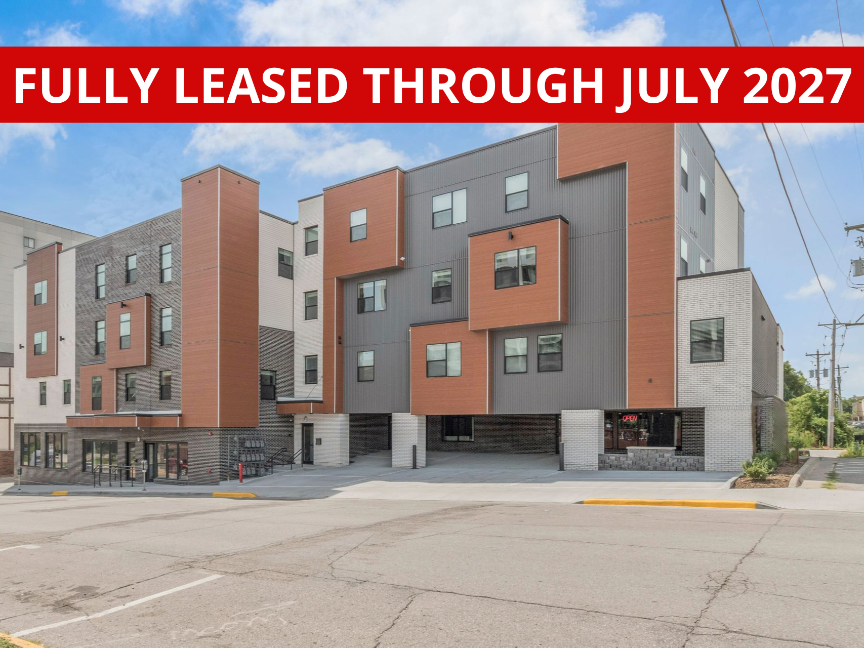 Exterior view of Clocktower Place, a modern apartment building in Ames, IA offering convenient living spaces close to ISU amenities.