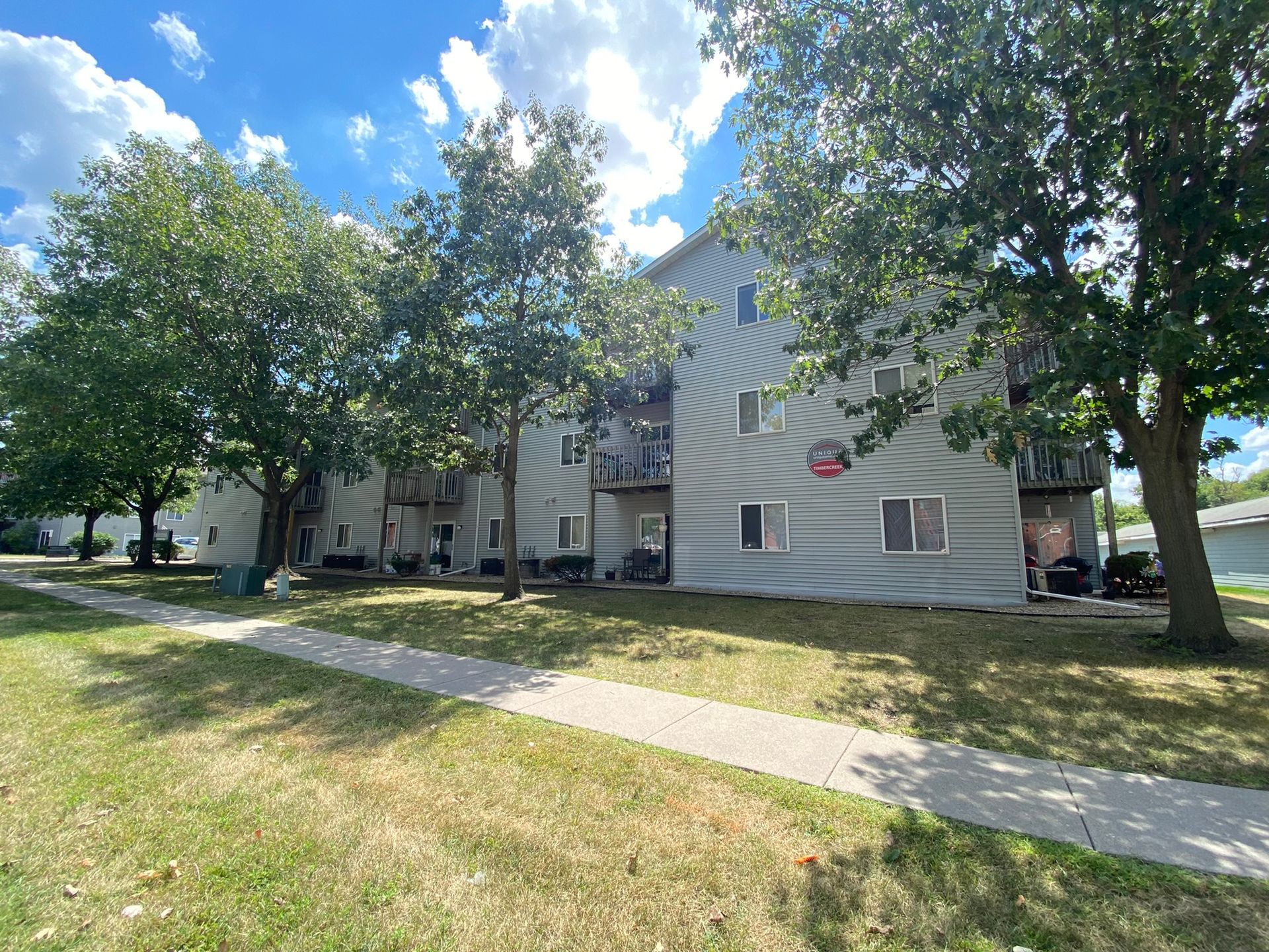 Exterior view of Timbercreek, a modern apartment building in Ames, IA offering convenient living spaces close to local & ISU amenities.