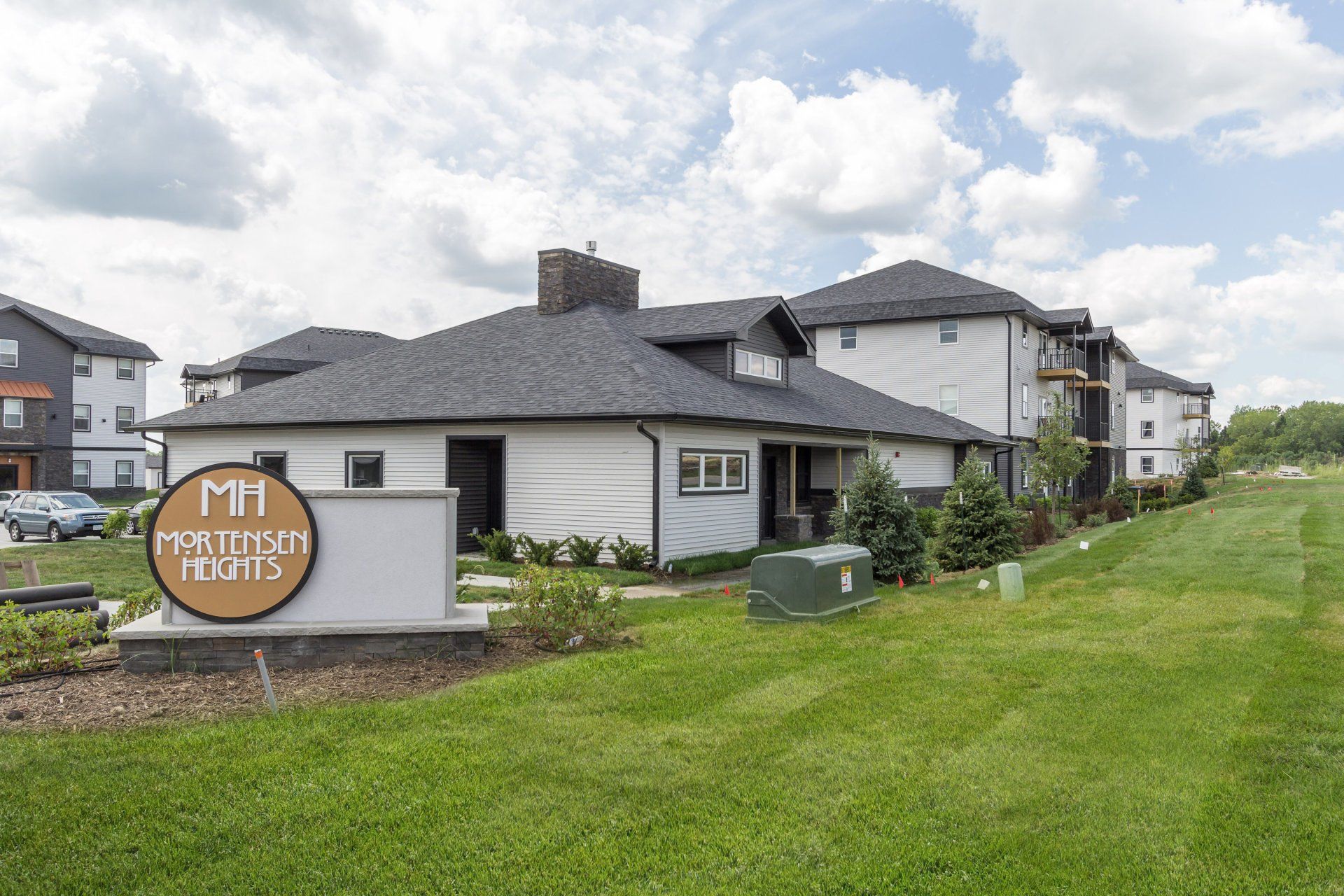 Exterior view of Mortensen Heights, a modern apartment complex in Ames, IA offering convenient living spaces close to local & ISU amenities.