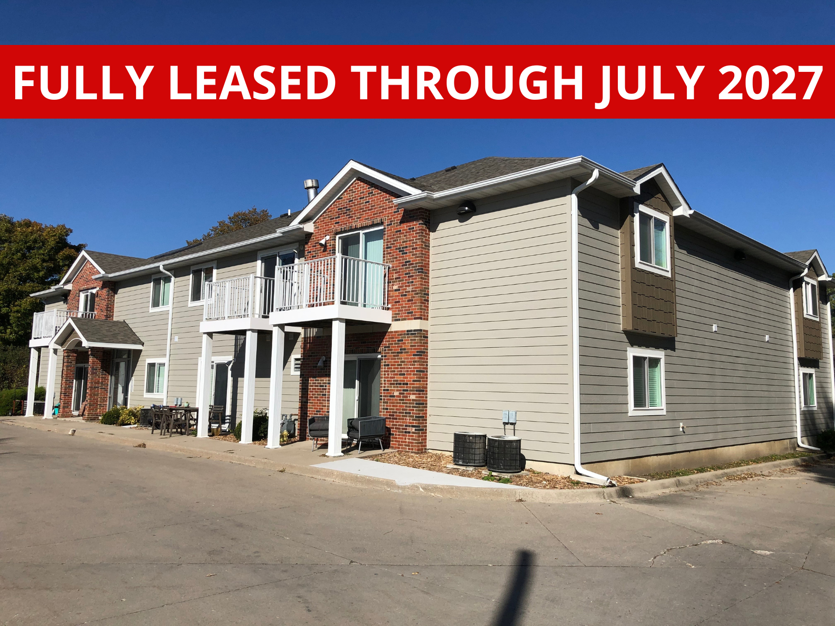 Exterior view of Town Centre, a modern apartment building in Ames, IA offering convenient living spaces close to local & ISU amenities.