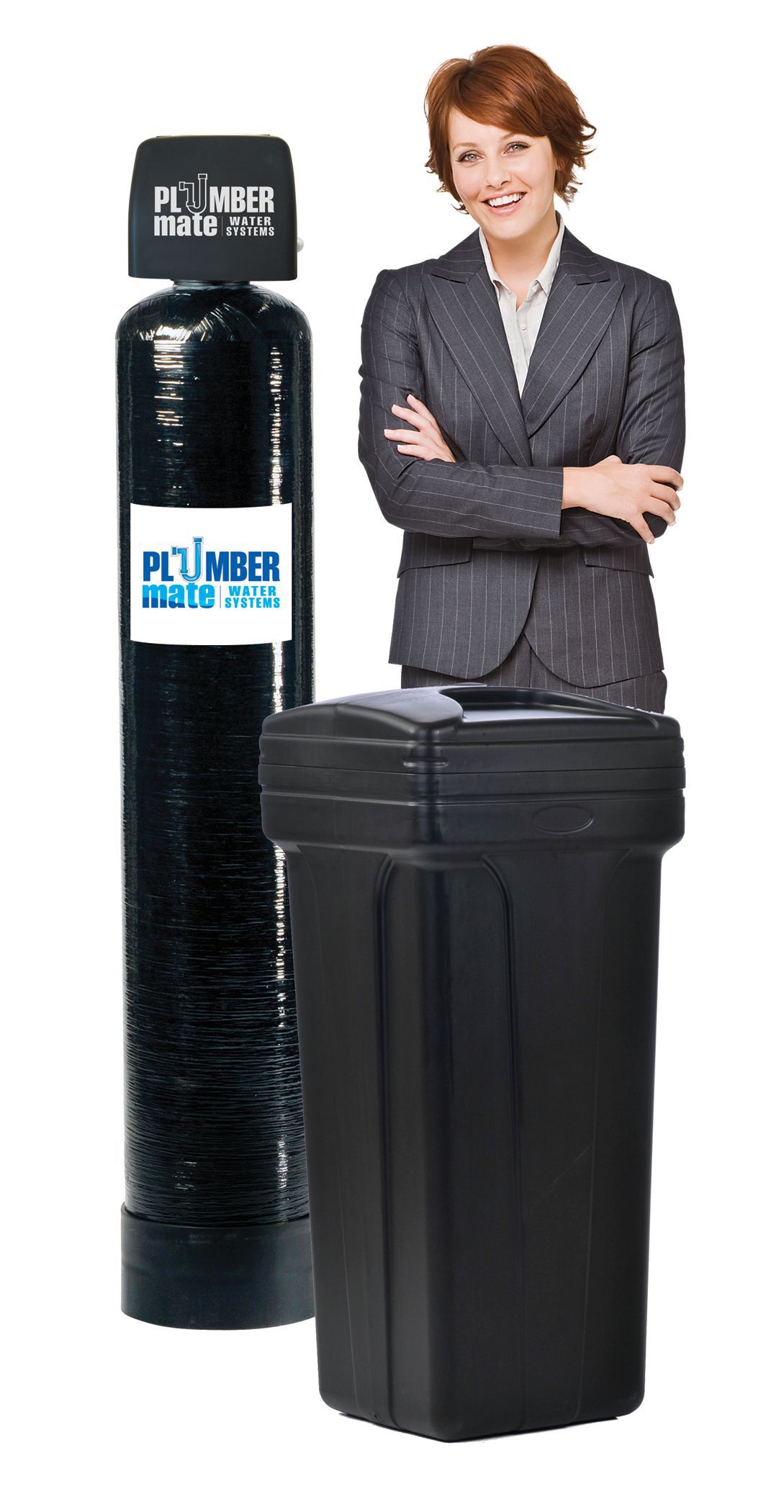 Woman stands next to a water softener and a tall, black filtration tank, smiling with arms crossed.