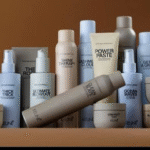 Assorted white and beige cosmetic bottles and tubes arranged on a shelf