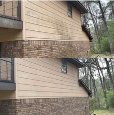 Before and after comparison of house siding being cleaned of dirt and mold, showing a tan exterior wall.