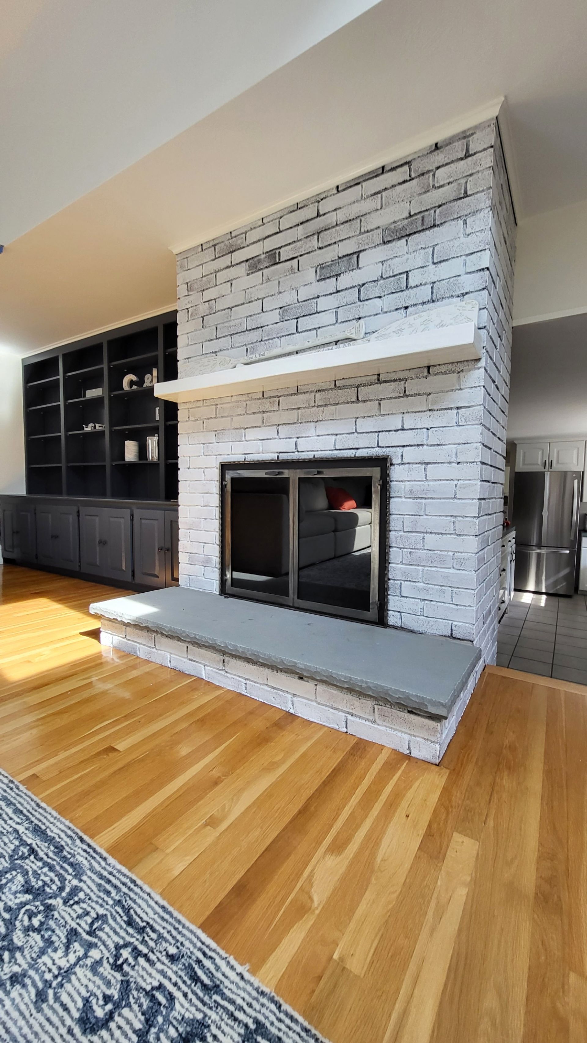 There is a fireplace in the middle of the living room.