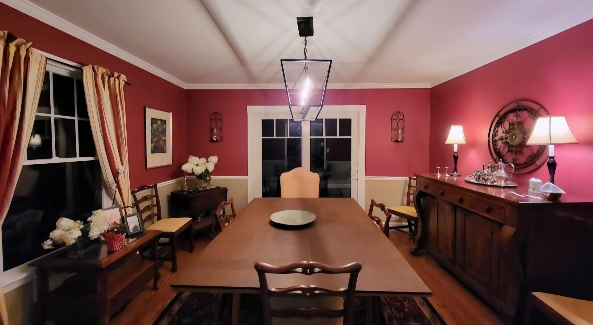 A dining room with a long table and chairs
