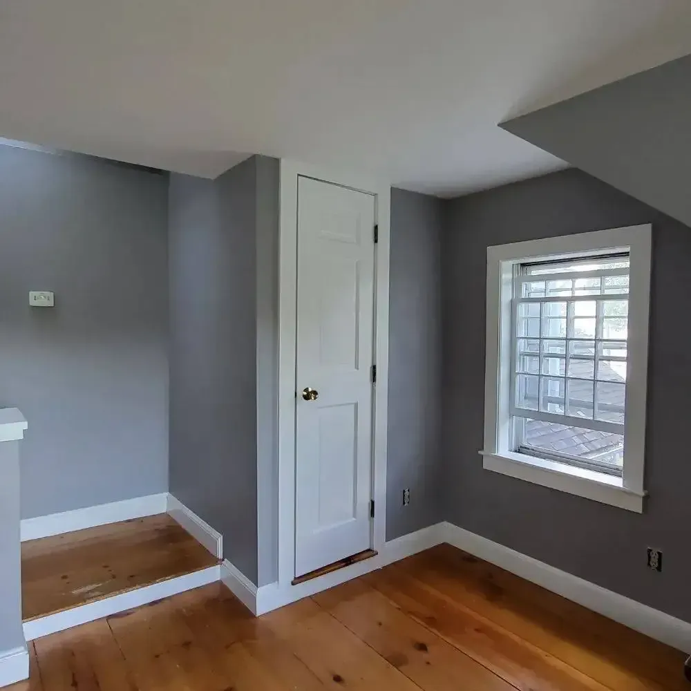 An empty room with a window and a door