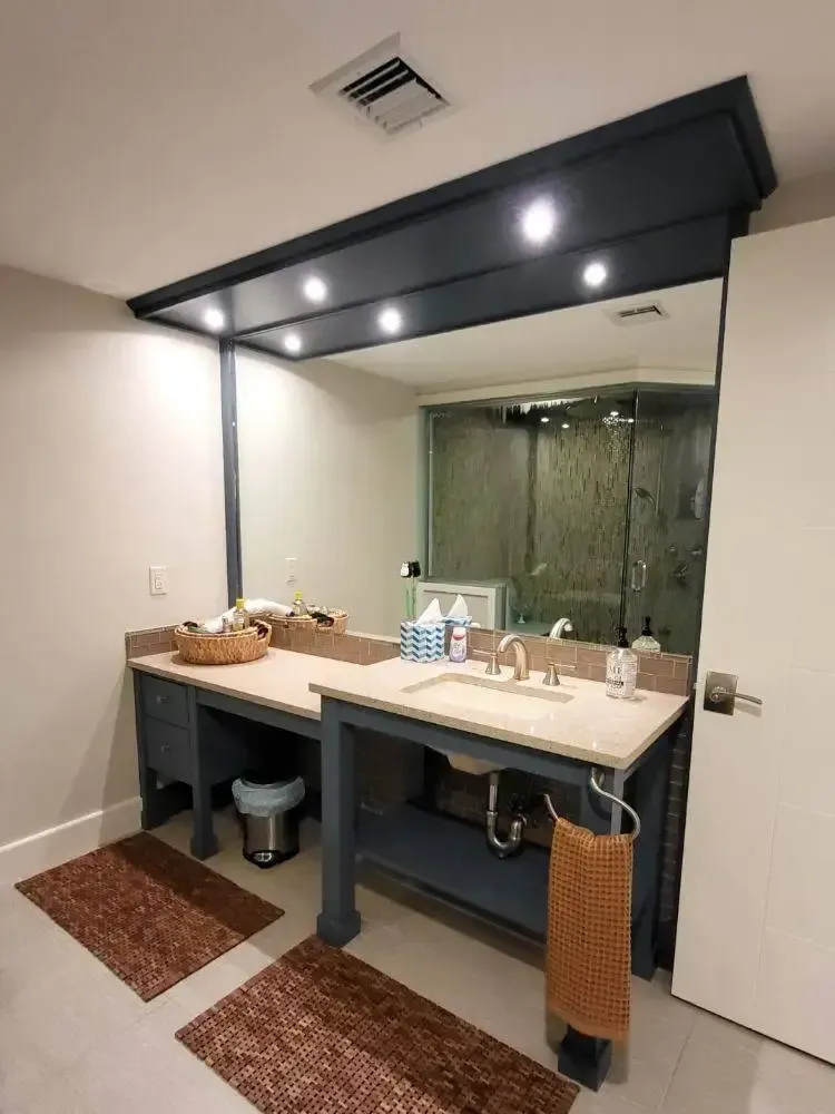 A bathroom with two sinks and a large mirror
