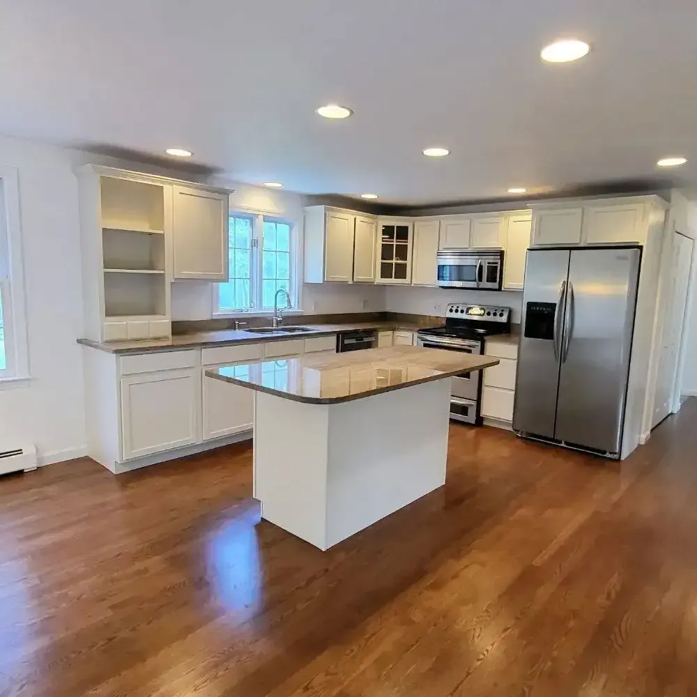 A kitchen with white cabinets and stainless steel appliances