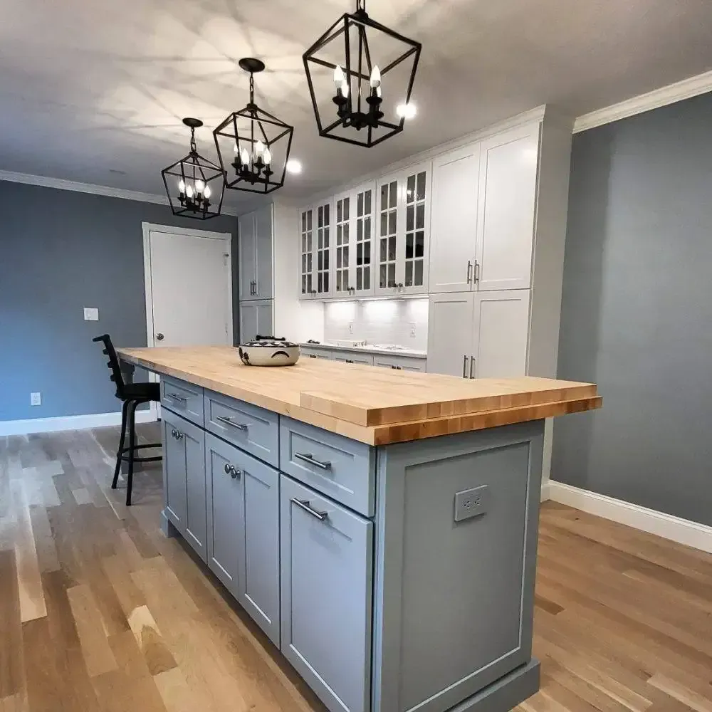 A kitchen with a large island and a wooden counter top