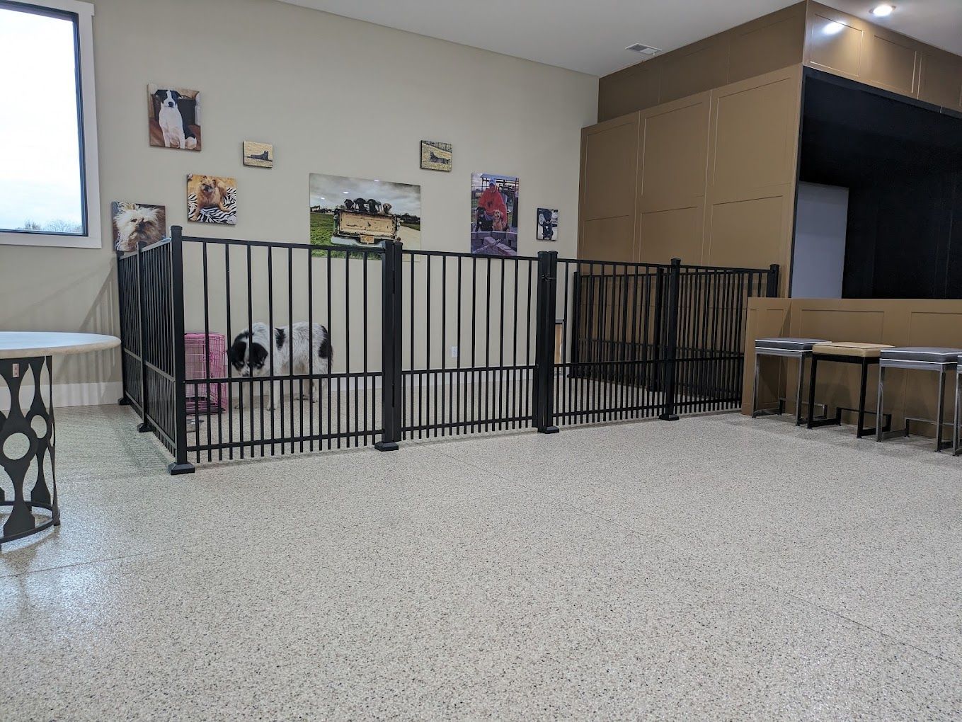 A room with a fence and a table in it.