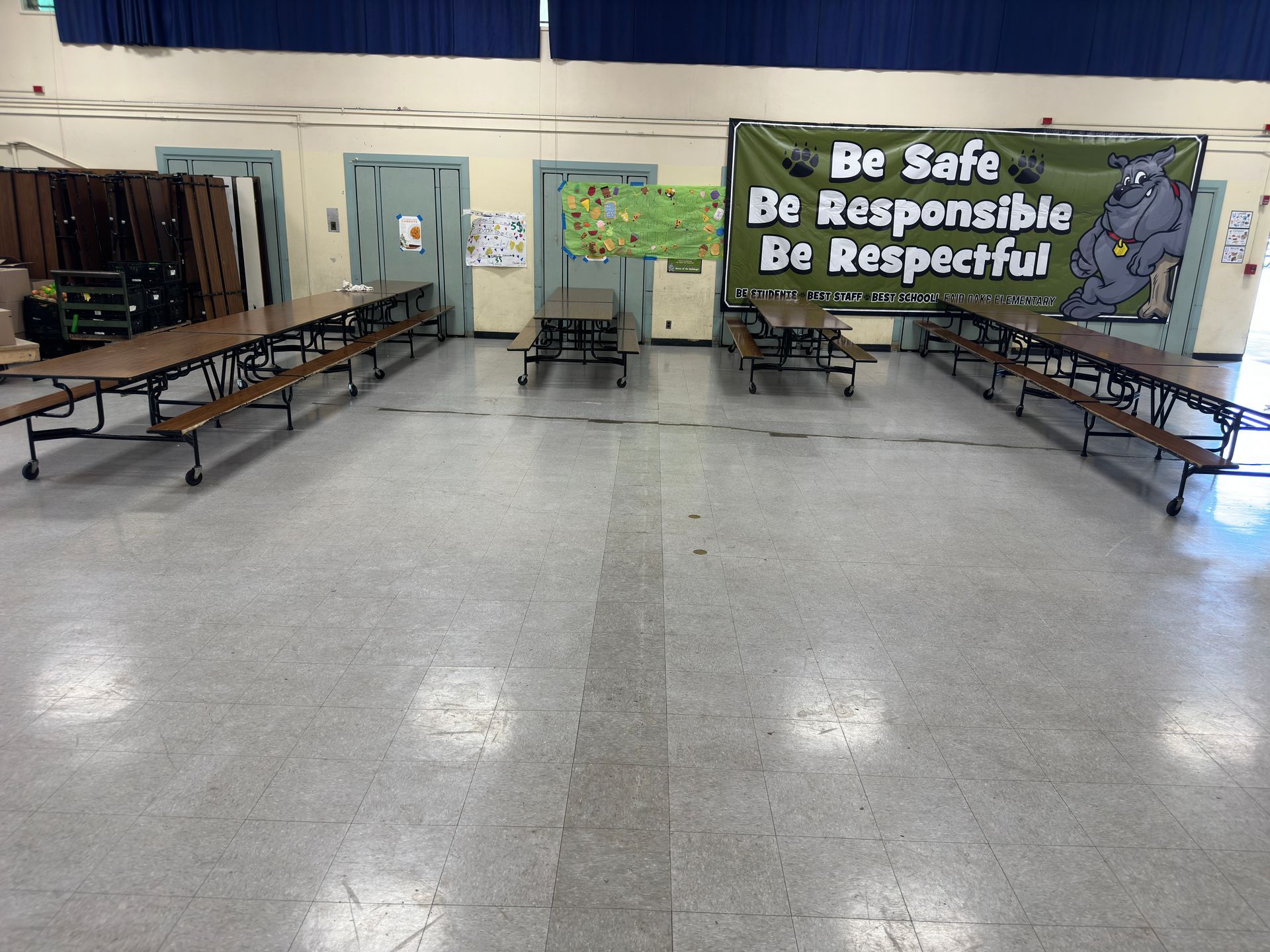 A large room with tables and benches and a sign that says be safe be responsible be respectful