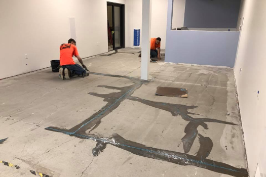 A picture of a tiger on the floor of a cafeteria