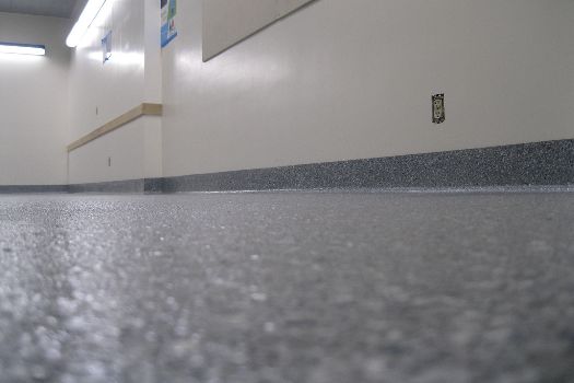 A man is driving a diamatic machine down a hallway