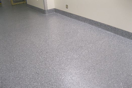 A close up of a shiny concrete floor in a hallway.
