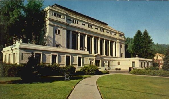 A large white building with columns and a walkway leading to it