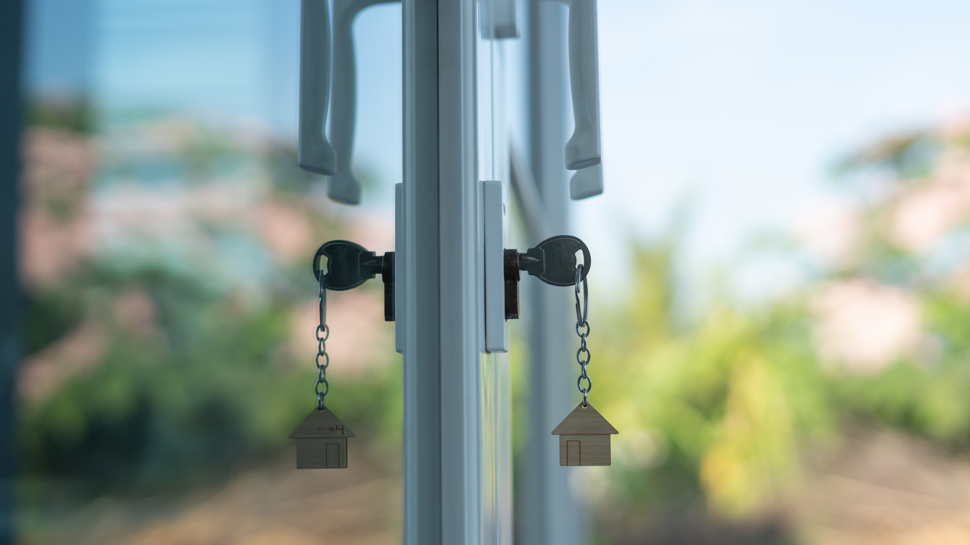 A wind chime with two keys hanging from it.