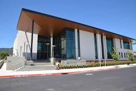 A large white building with a wooden roof and a lot of windows.