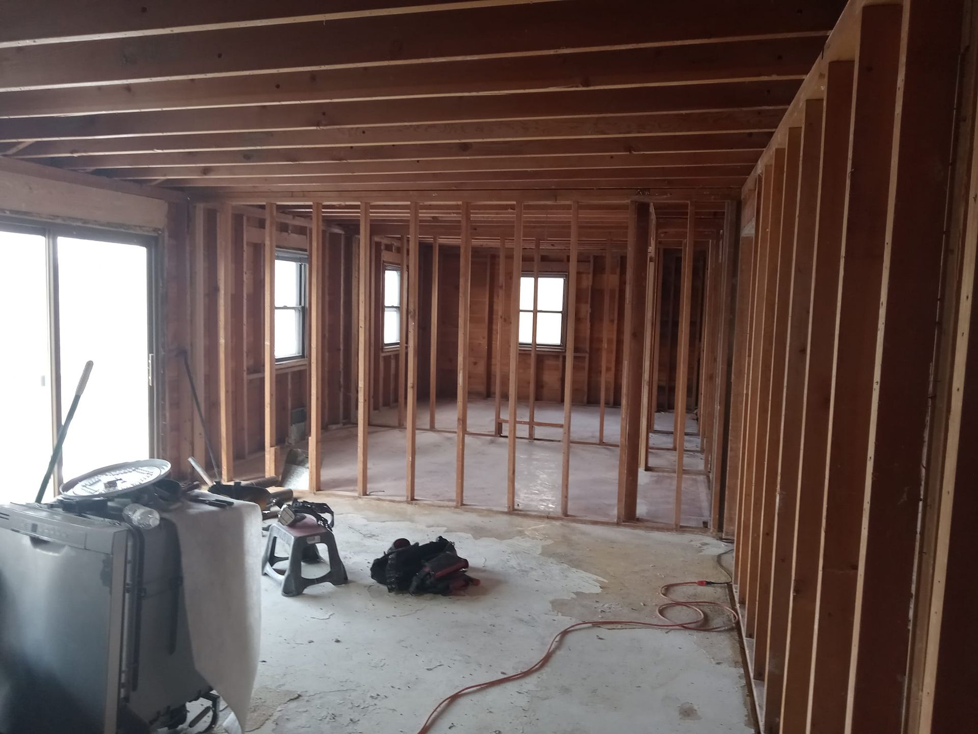 A room that is being built with a lot of wooden beams