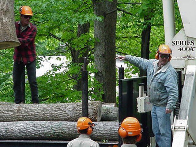 A man wearing a hard hat stands in front of a series 400a machine