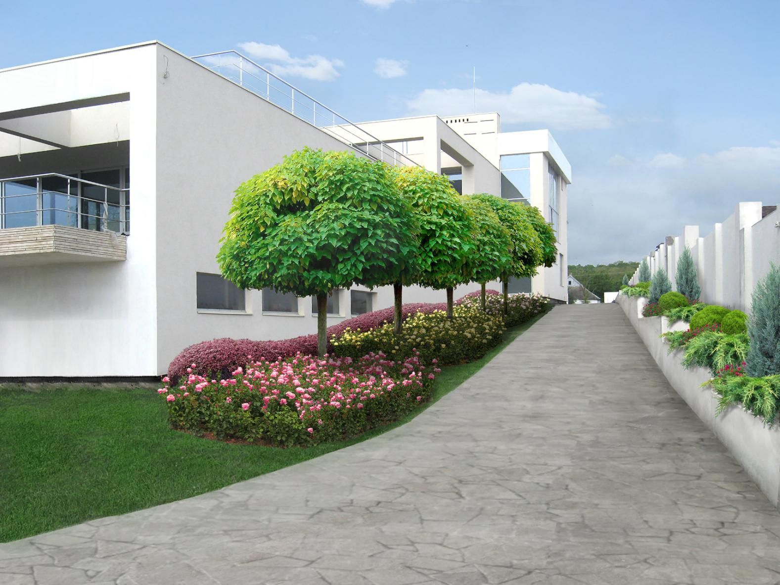 Modern white building with landscaped path, rounded trees, and colorful flower beds.