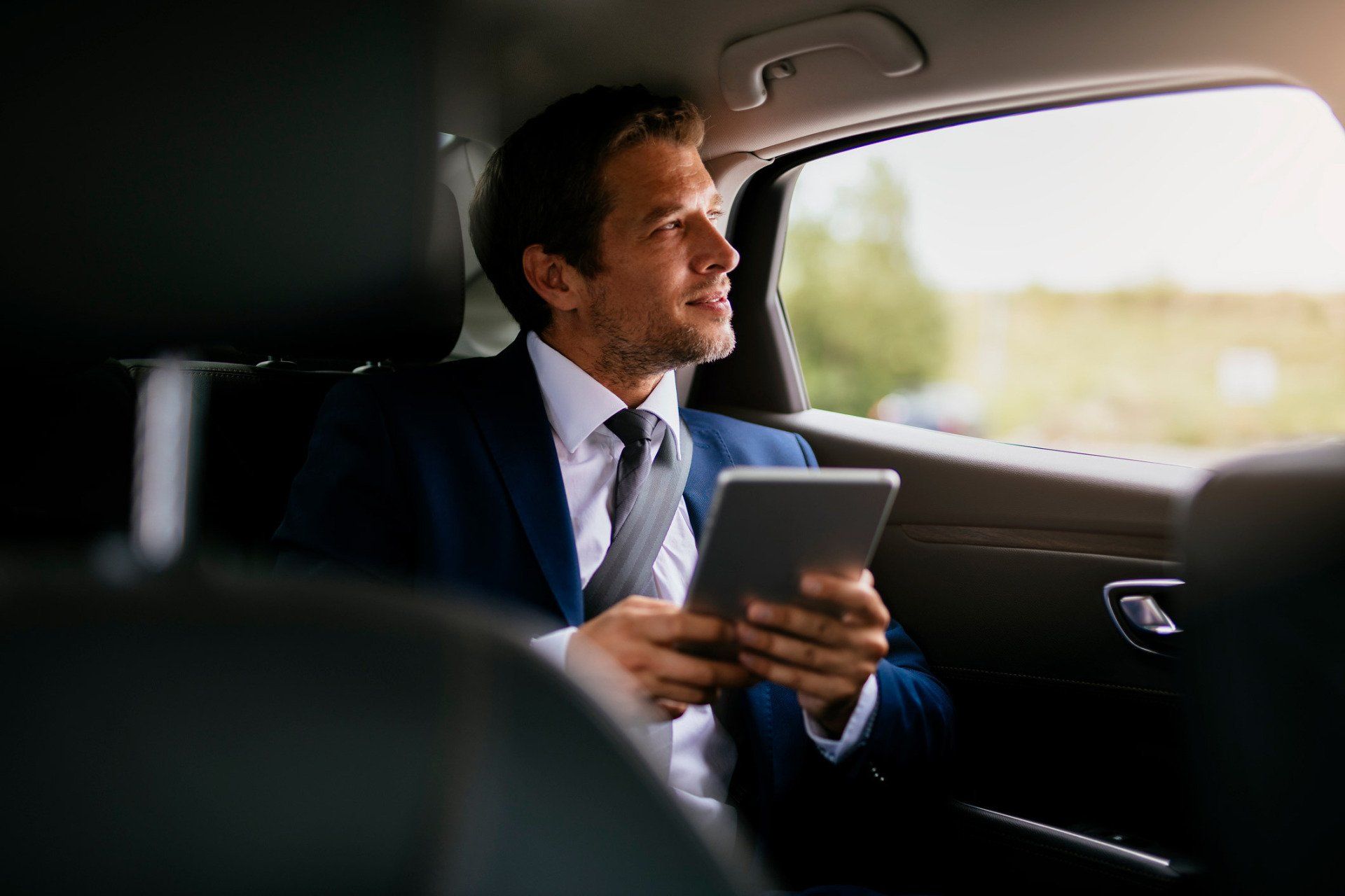 Man Using Tablet — East Meadows, NY — AES Luxury Transportation LLC