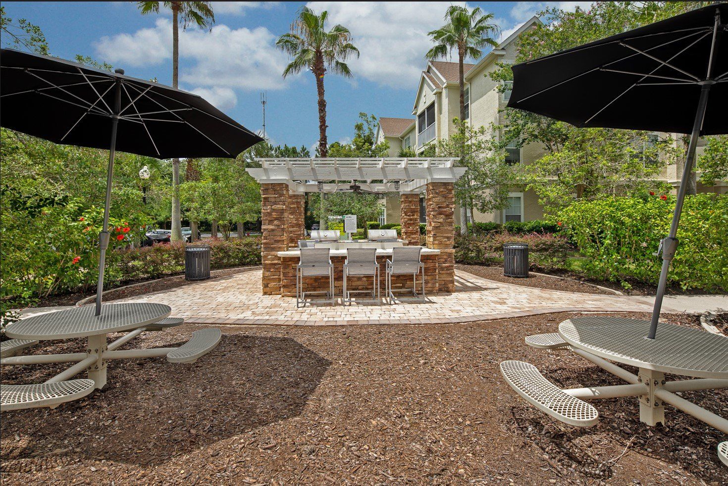 Eddison at Deerwood Park | Apartment Outdoor Lounge with Seating Area and Grill