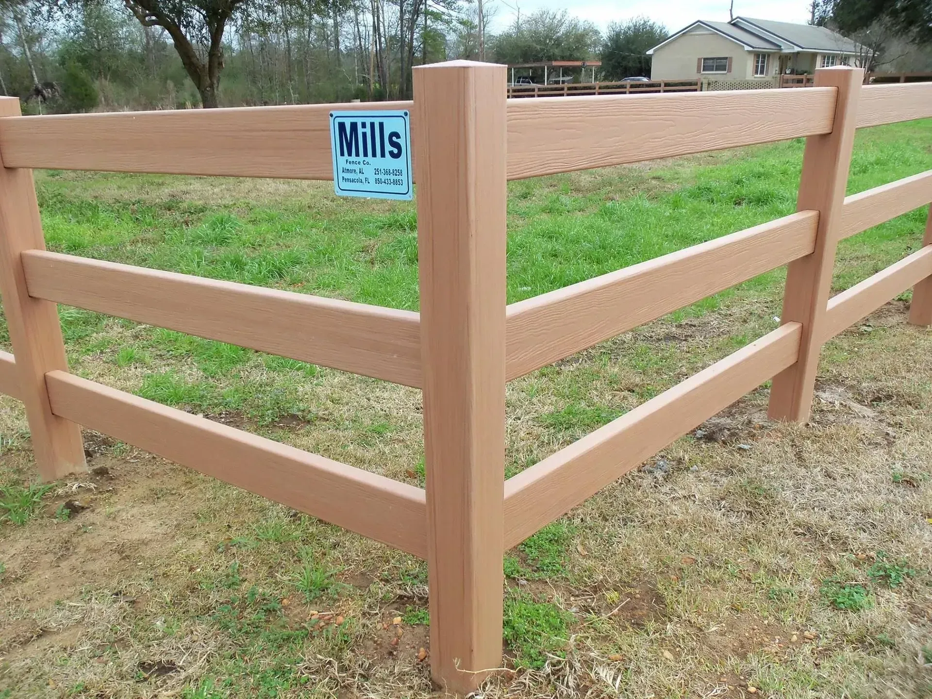A wooden fence with a mills sign on it