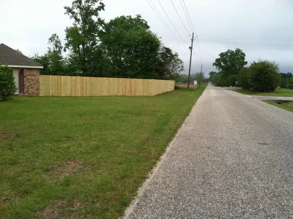 A wooden fence along the side of a road
