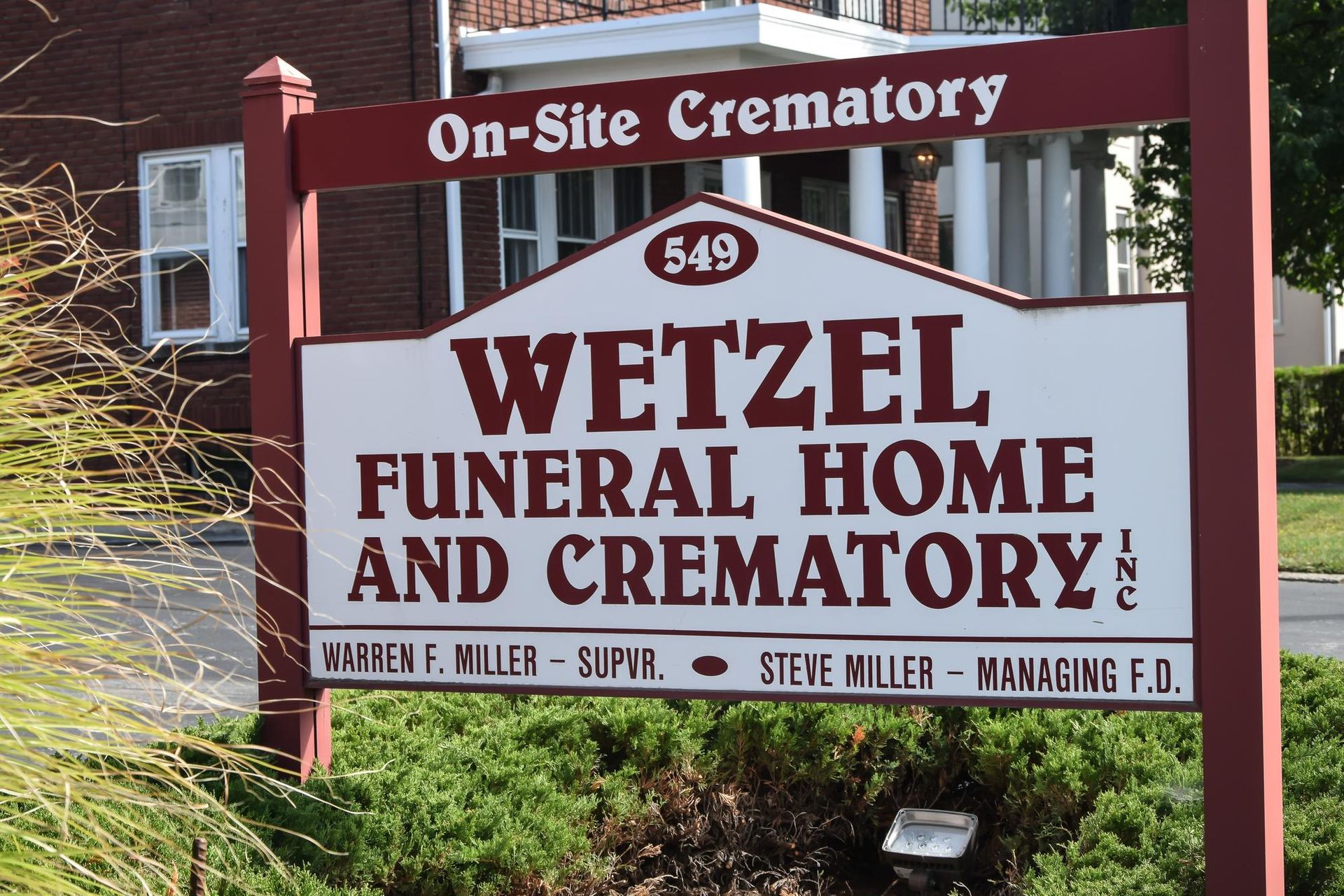 Wetzel Funeral Home and Crematory sign with maroon lettering and 