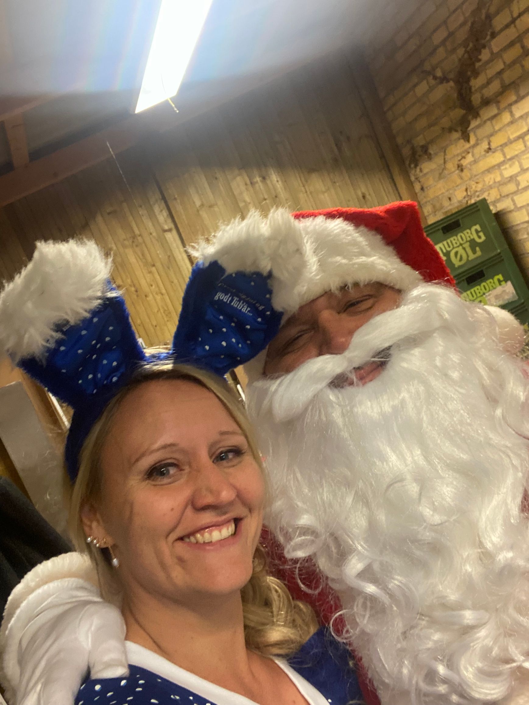 En kvinde poserer til et billede med julemanden.