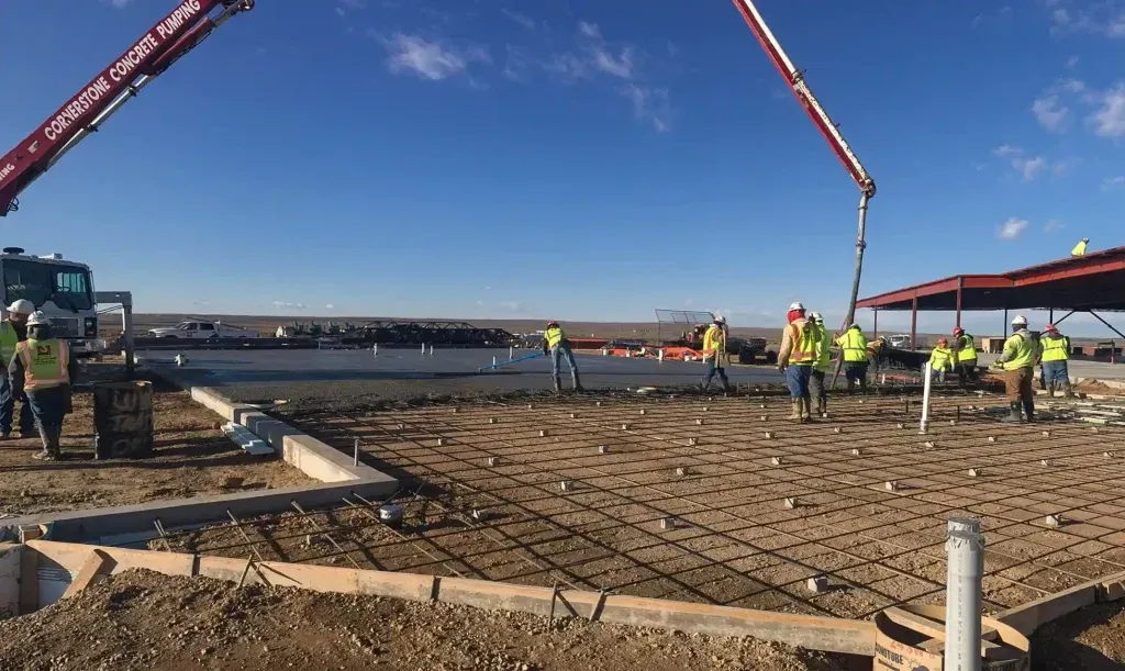 A group of construction workers are working on a residential construction site