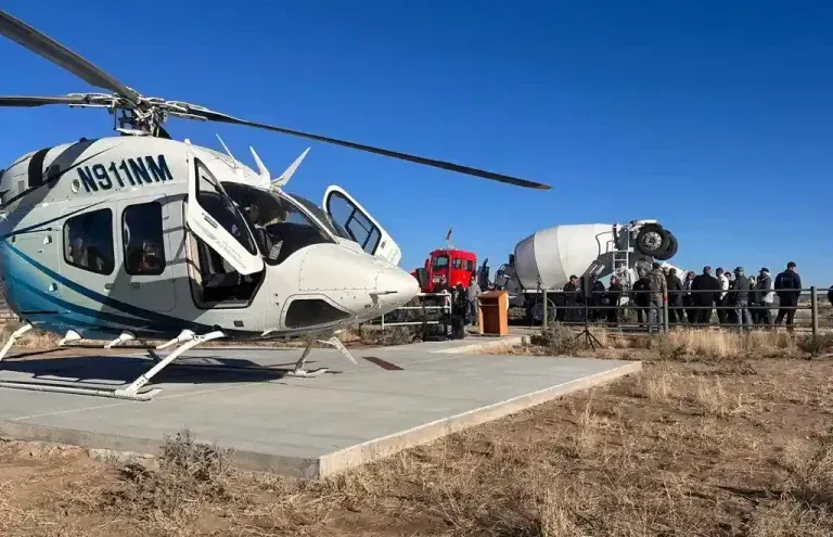 A helicopter is parked on a concrete platform made by Mesa Sand and Gravel