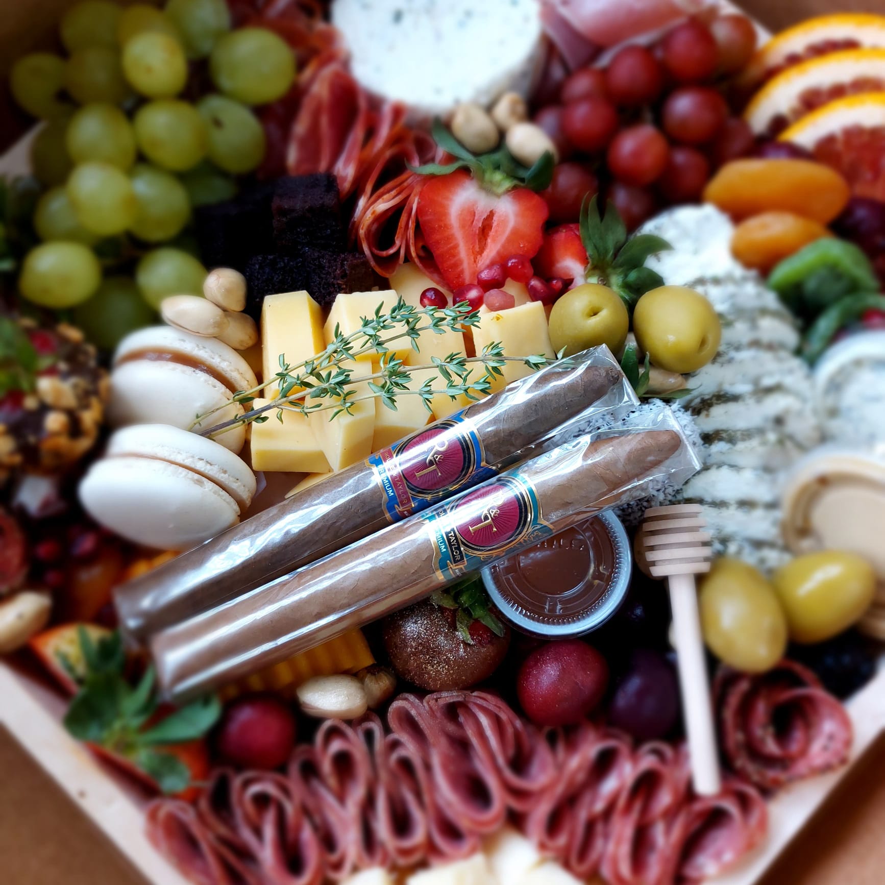A wooden tray filled with a variety of fruits and vegetables.