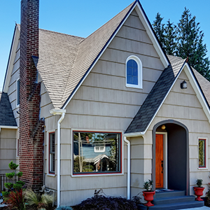 A house with a brick chimney on the side of it