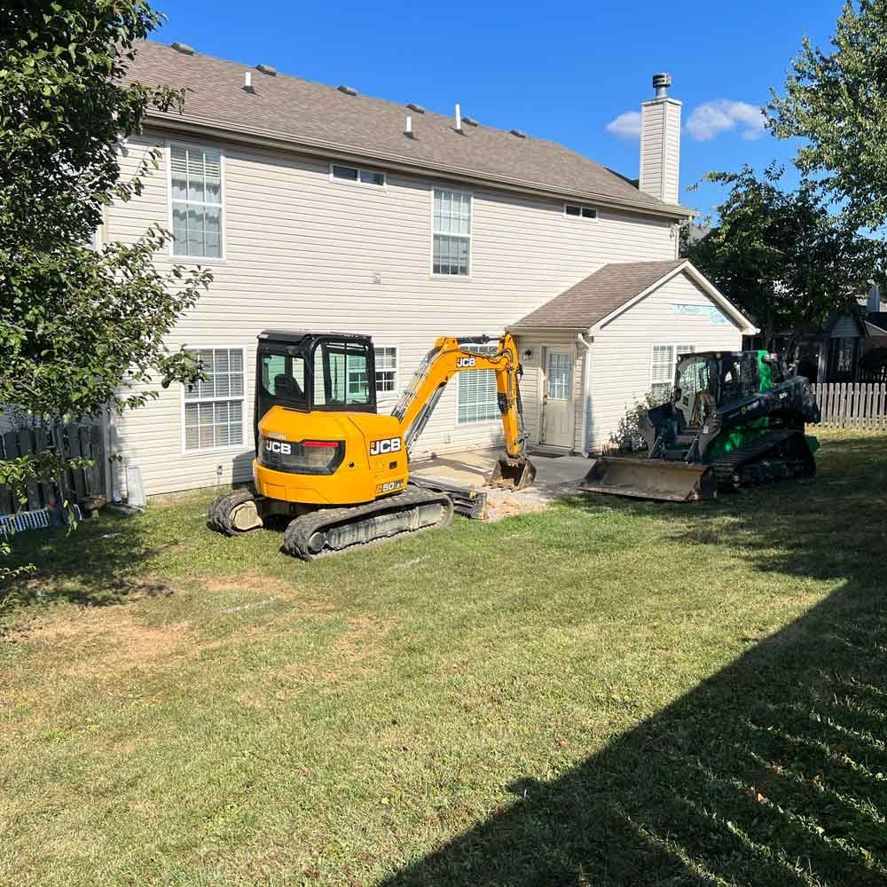 Backhoe Digging on The Lawn — Winchester, KY — Underground Kings, LLC
