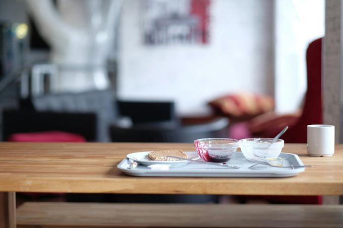 A wooden table with a tray of food on it