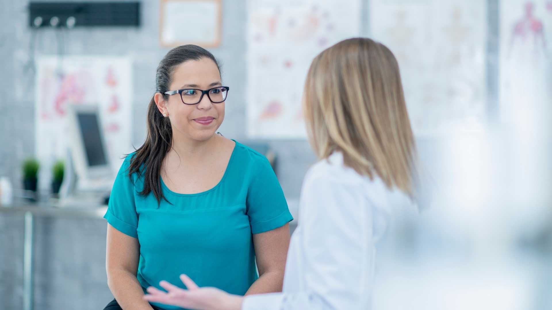 A doctor is talking to a patient in a hospital.