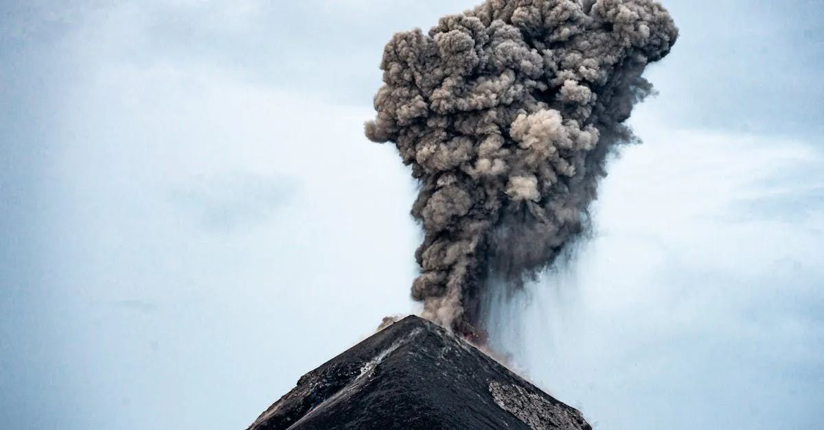 A volcano is erupting with smoke coming out of it.