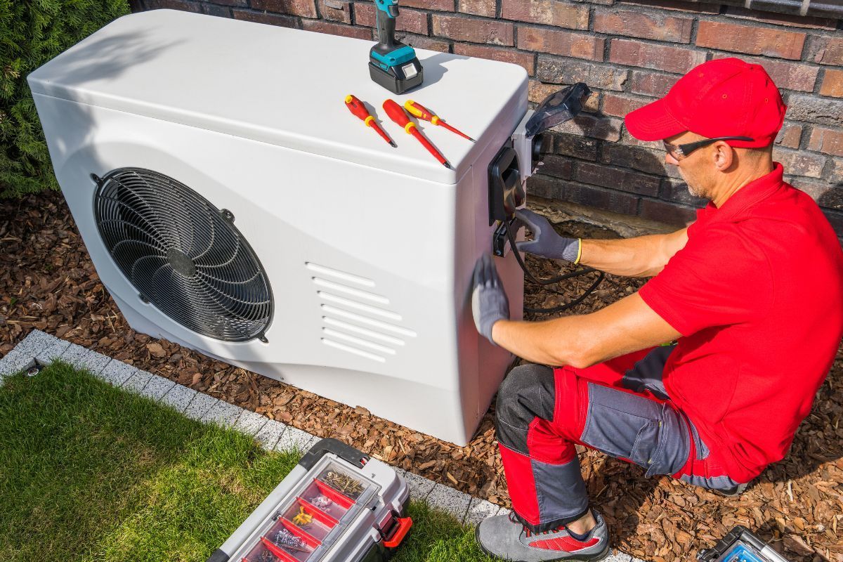 Electrician working on outside AC unit