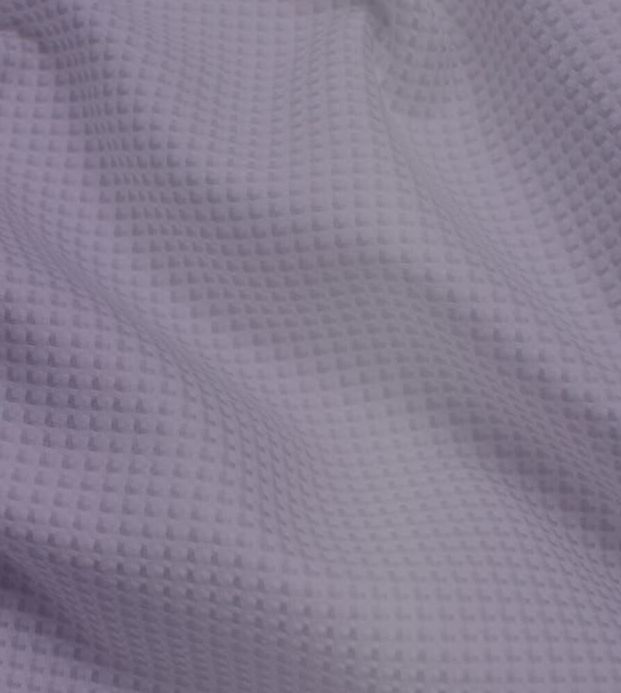 A close up of a white fabric with a pattern on it.