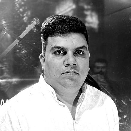 A black and white photo of a man in a white shirt.