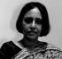 A black and white photo of a woman in a sari.