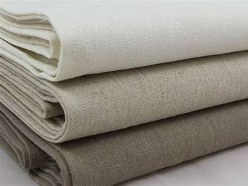 Three pieces of fabric are stacked on top of each other on a table.