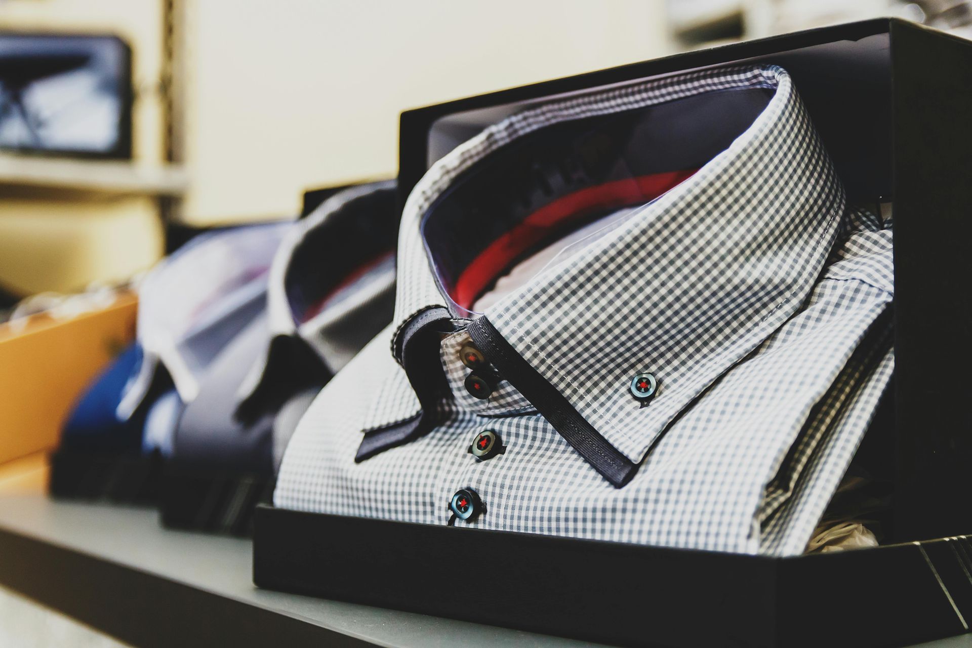 A bunch of shirts are stacked on top of each other in a box.