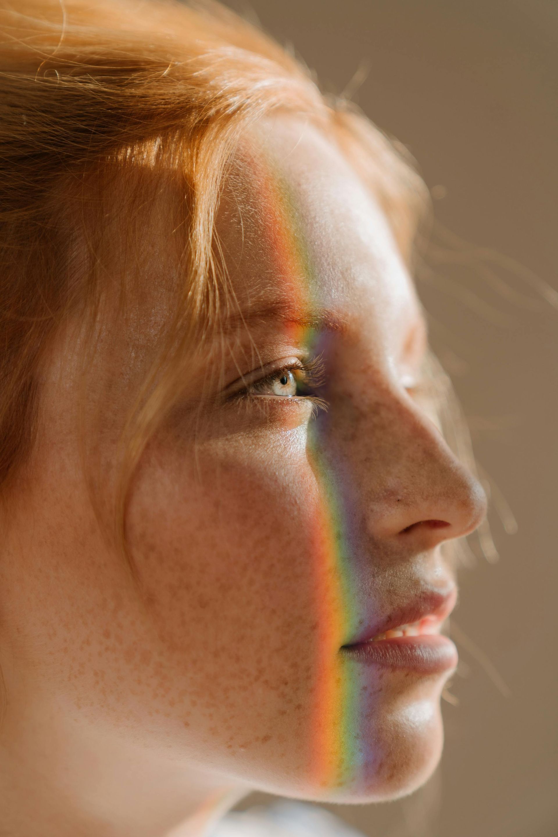 A woman with a rainbow coming out of her face.